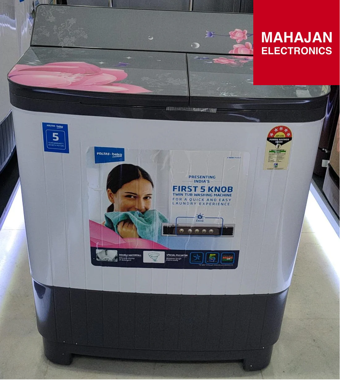 Washing machine with promotional poster on a white background, featuring Mahajan Electronics branding.
